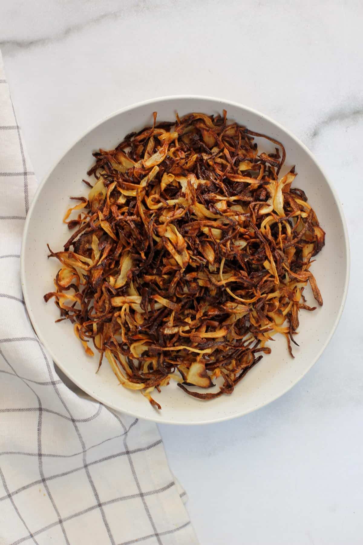 air fried onions in a white bowl