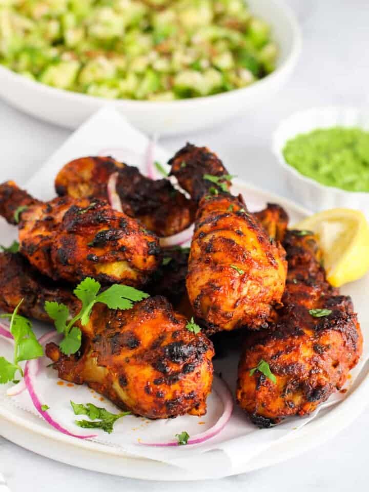 tandoori chicken served with chutney and cucumber salad