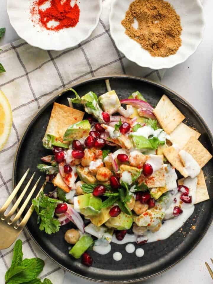 avocado chickpea chaat in a black plate