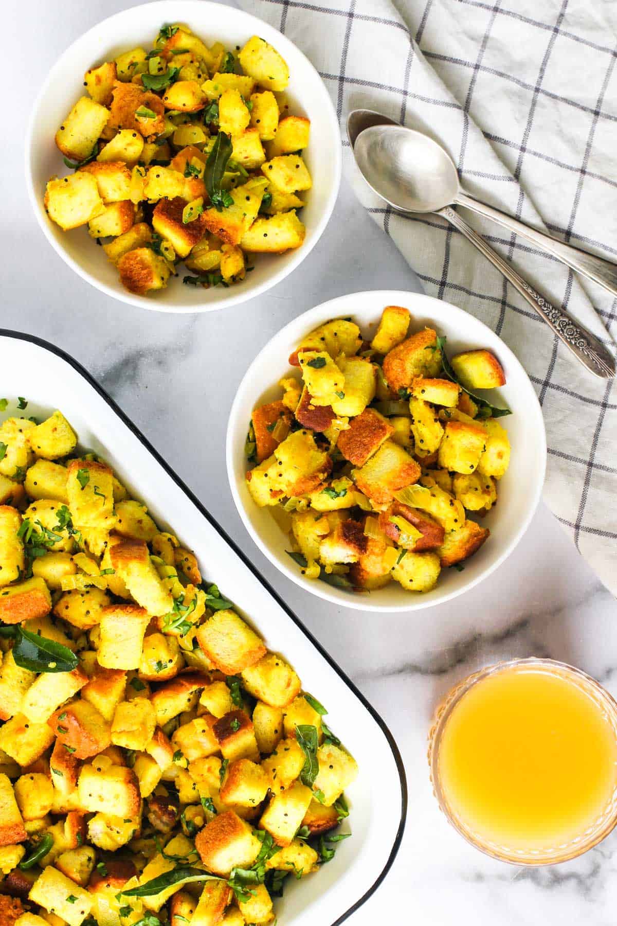Bread upma served in two white bowls