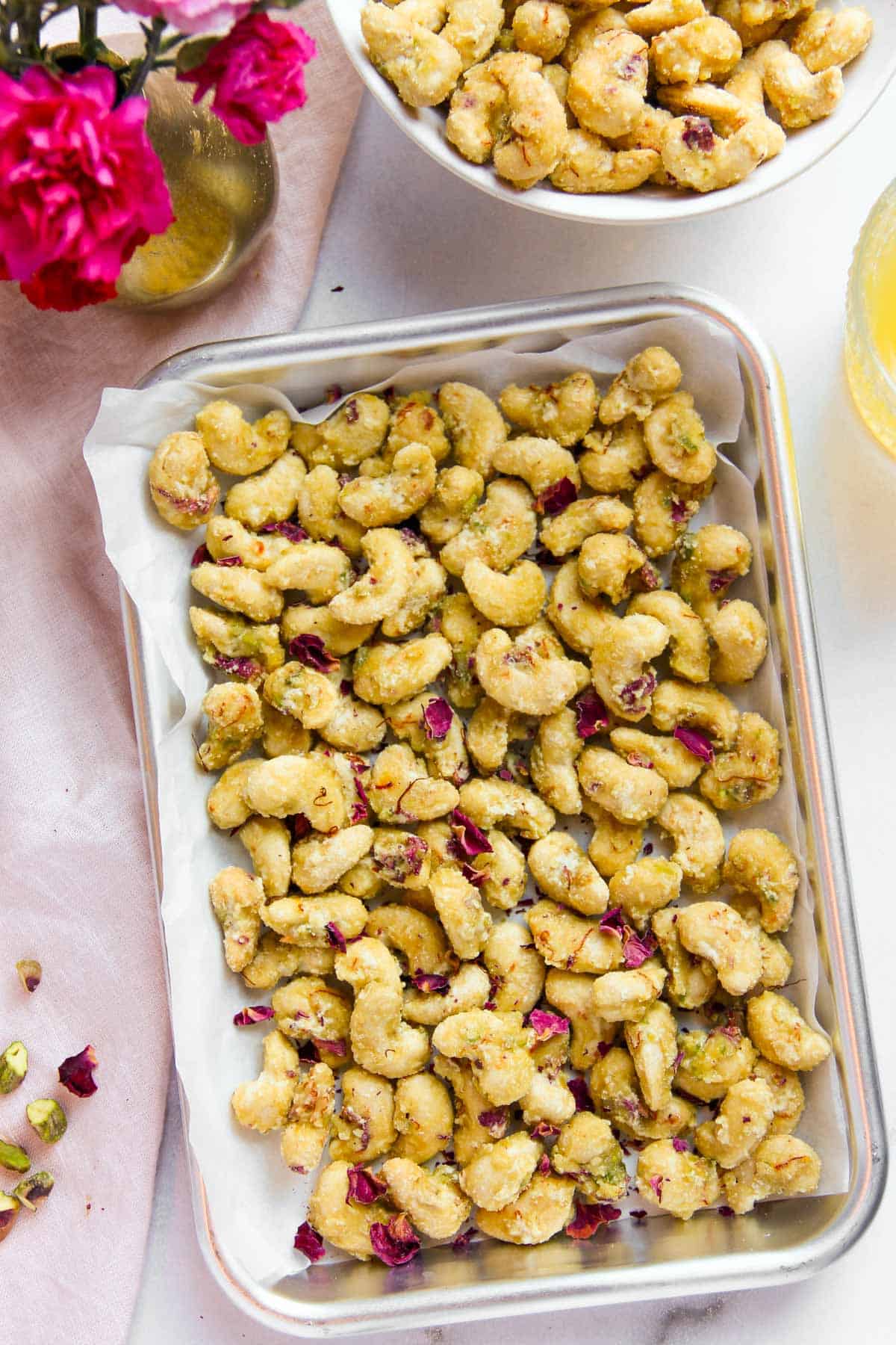 candied cashews in tray and bowl