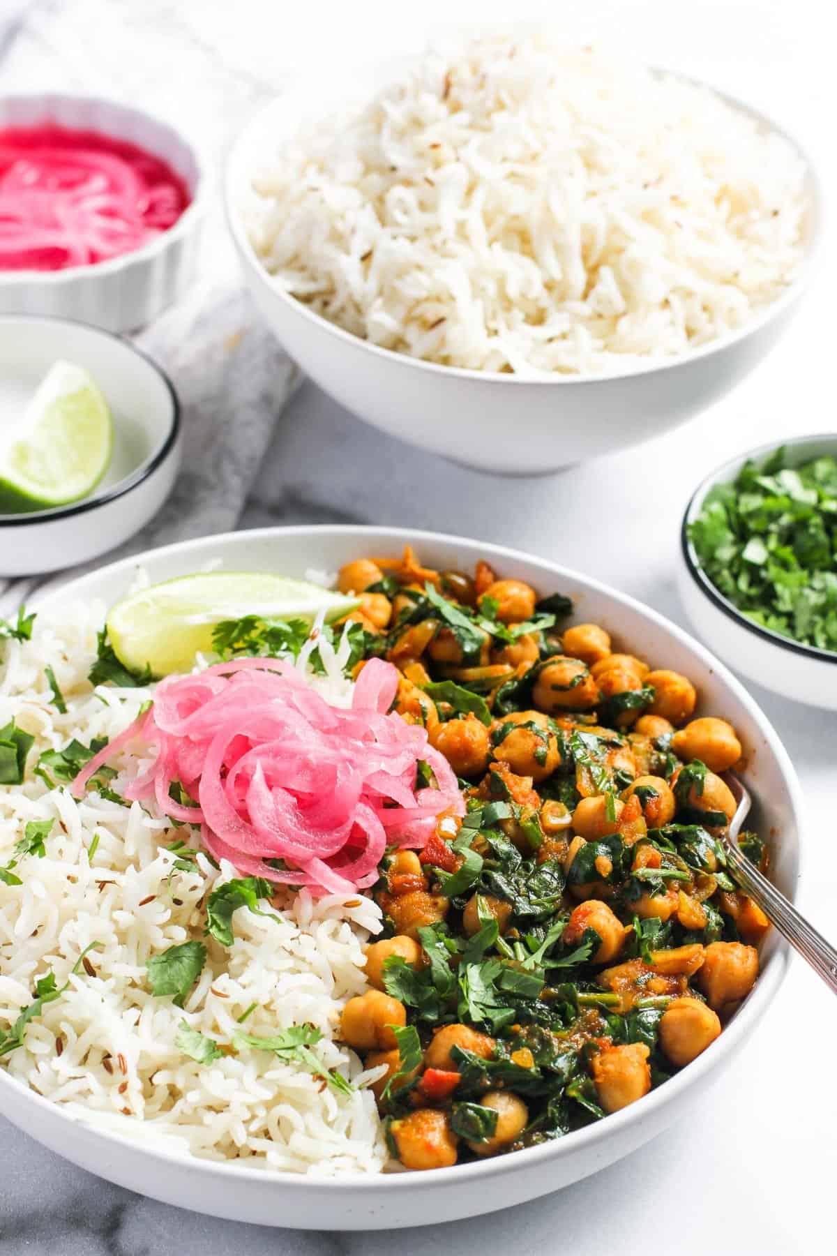 saag chana served with rice and pickled onions