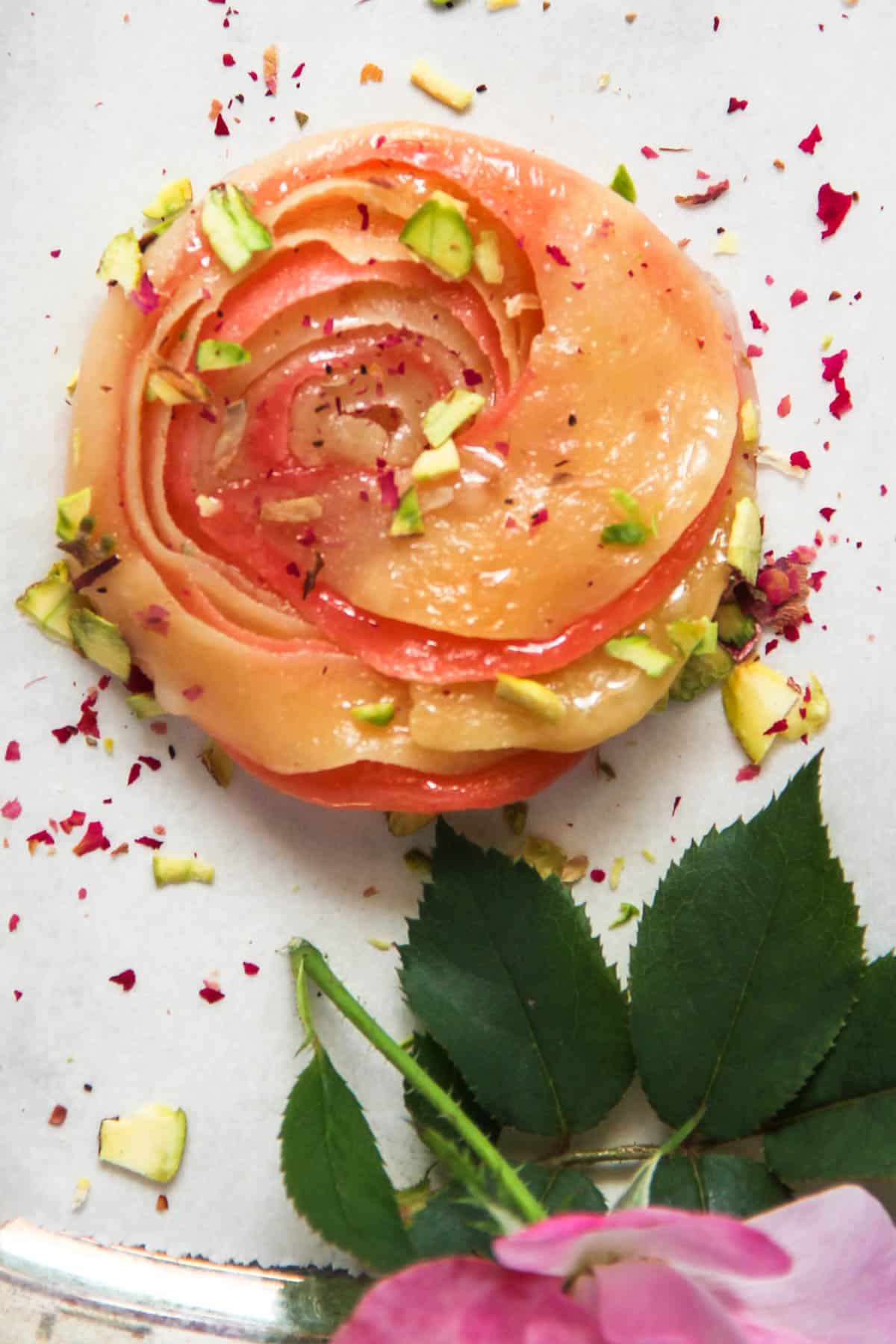 close up chirote garnished with pistachios and dried rose petals