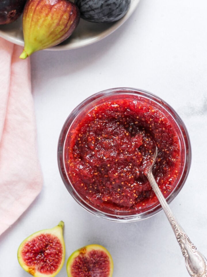fig jam in a jar with fresh figs on the side
