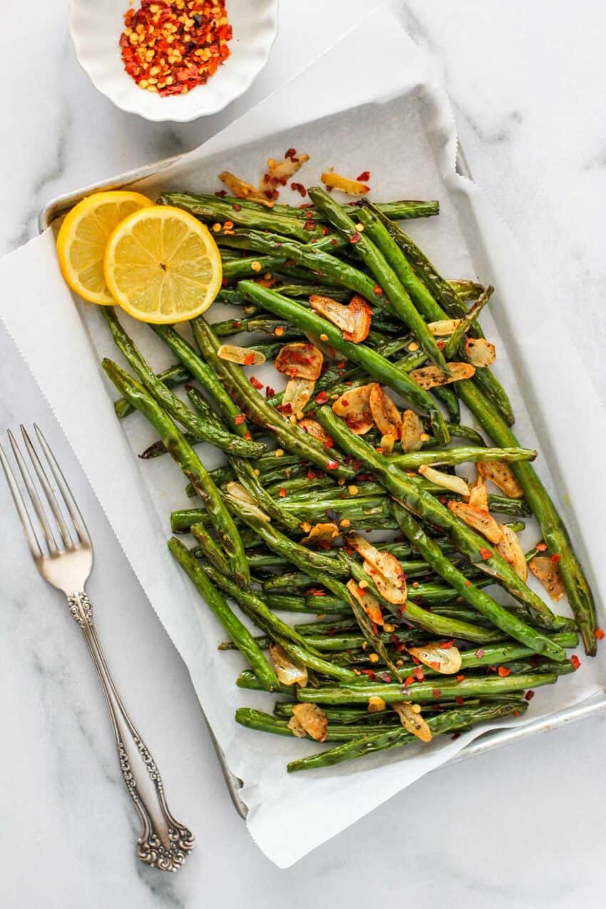 air fried green beans served with lemon wedges