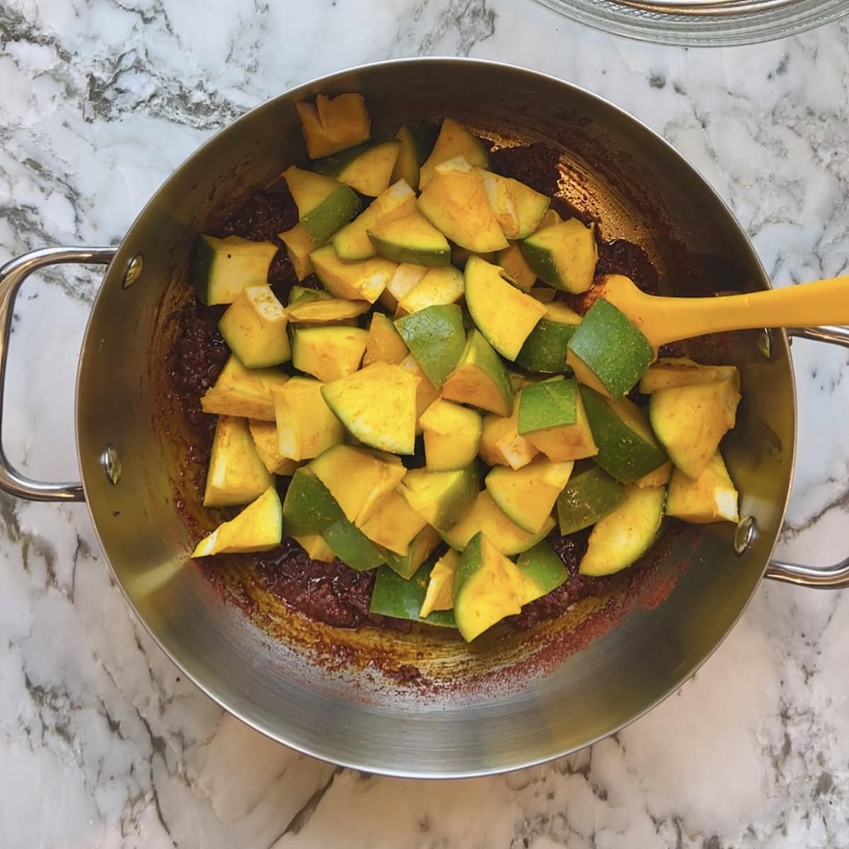 Mango pieces added to the pickle masala.