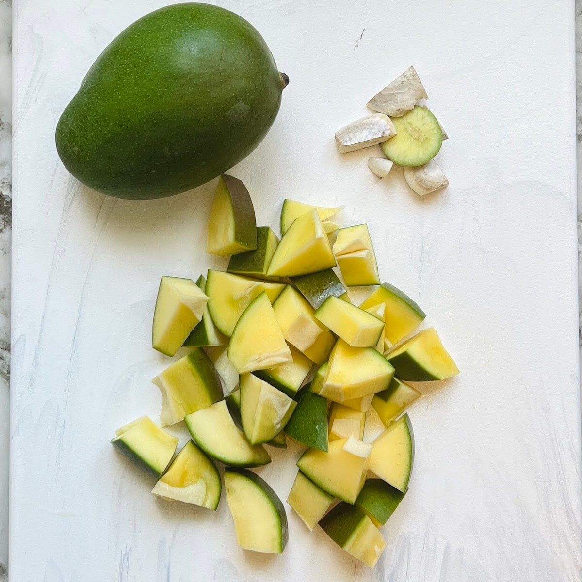 one whole green mango and one cut into small pieces