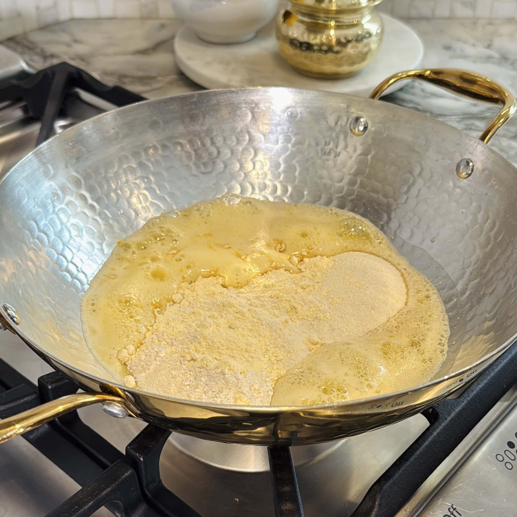 ghee and sooji in a pan.