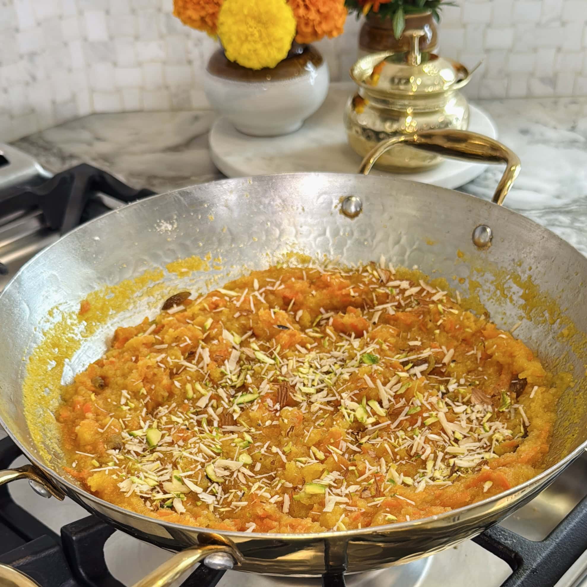 sheera garnished with nuts in a kadai.
