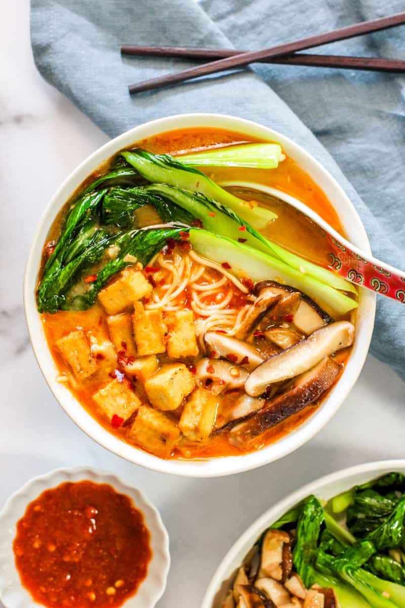 miso ramen soup served with chili garlic sauce on the side