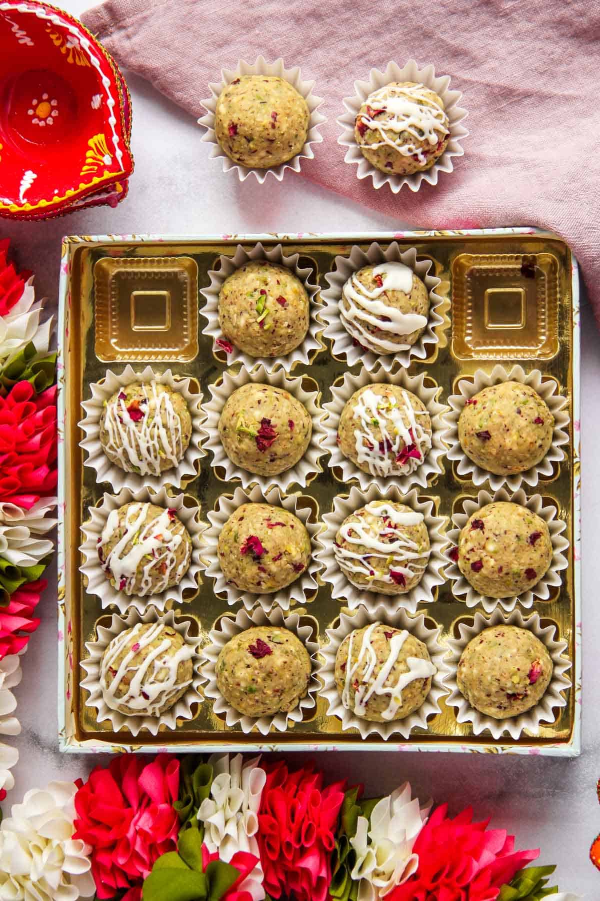 oats pistachio laddu in a festive mithai box