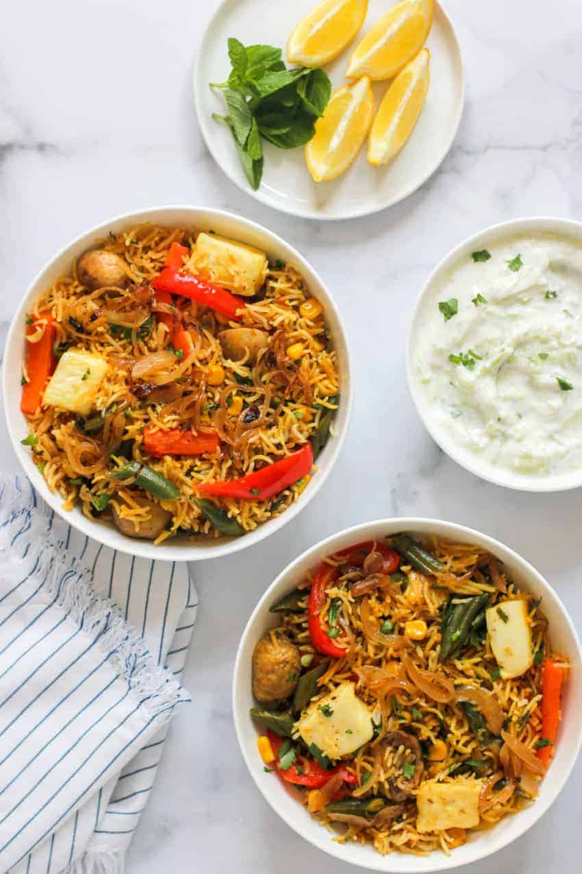 paneer & vegetable biryani with raita and lemon wedges