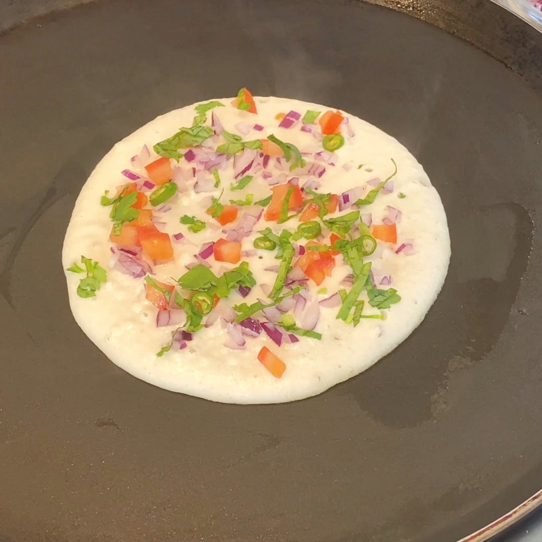 onion and tomatoes on uttapam