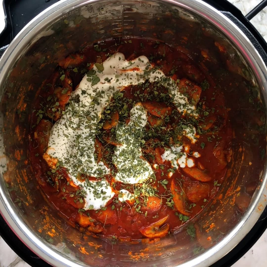 mushroom masala garnished with cream and kasoori methi