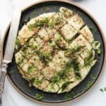 rava dhokla in a black platter