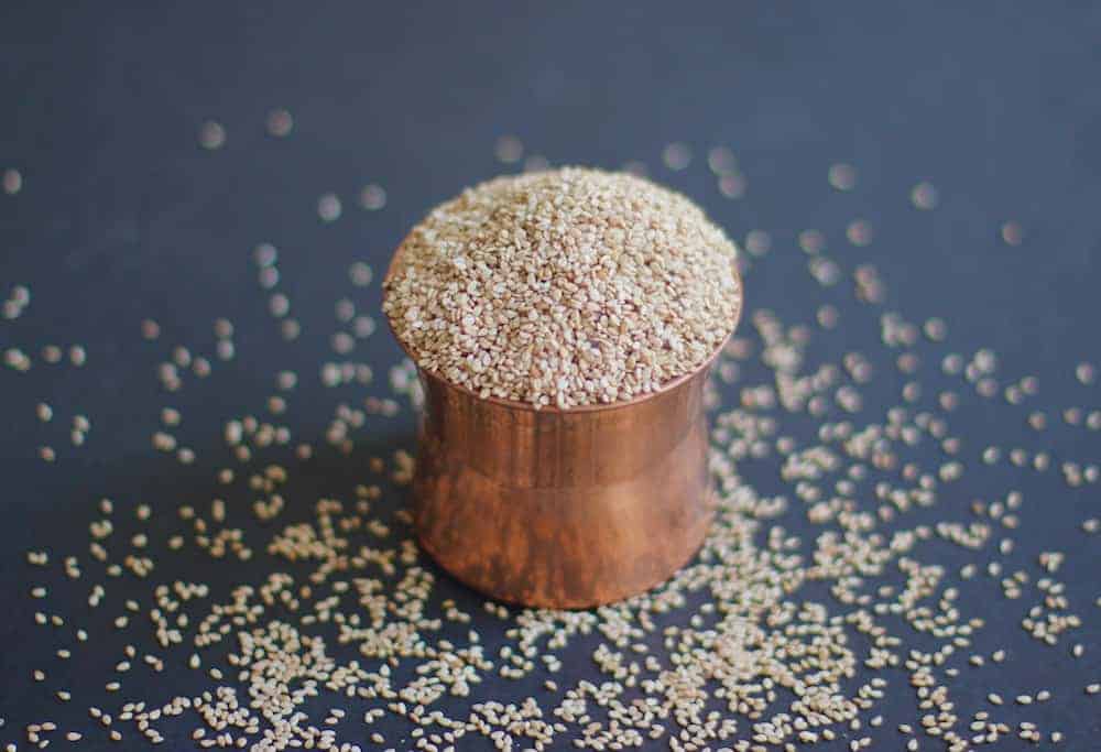 sesame seeds in a copper container