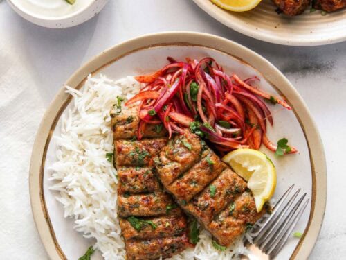 chicken seekh kebab served with laccha pyaaz over basmati rice