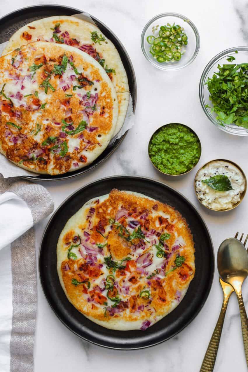 Uttapam served in 2 plates with chutneys