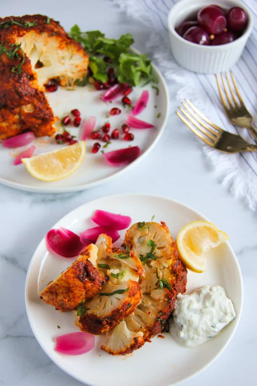 whole tandoori cauliflower cut into steaks and served with raita