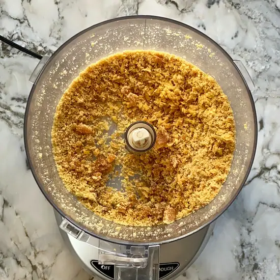 grated jaggery in a food processor jar.